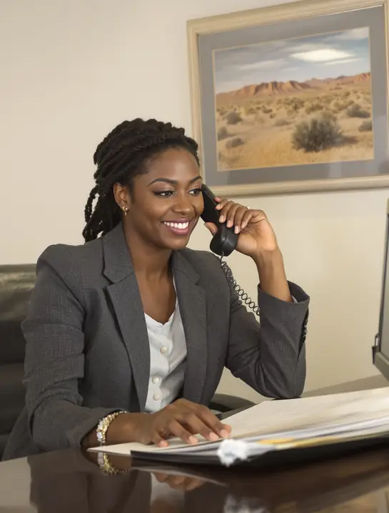 Tax professional on hold with the IRS at her desk