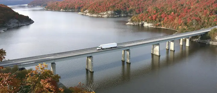 A tractor trailer crossing the Susquehanna River bridge in the fall