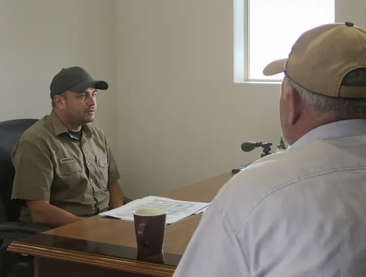 Going over a service contract at the desk with a customer